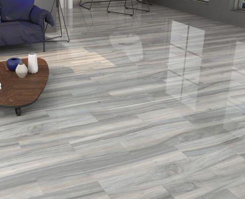 Modern living room with glossy light gray wood plank flooring reflecting window light.